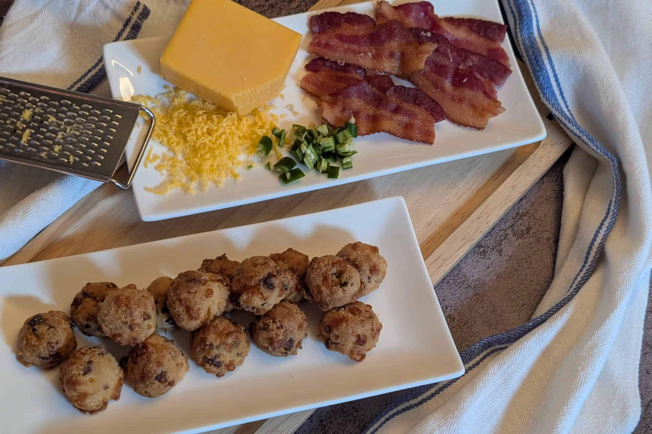 Bacon Cheddar Jalapeno Biscuit Bites - Plated with sliced of cooked bacon, diced jalapenos, and a block of shredded cheddar cheese